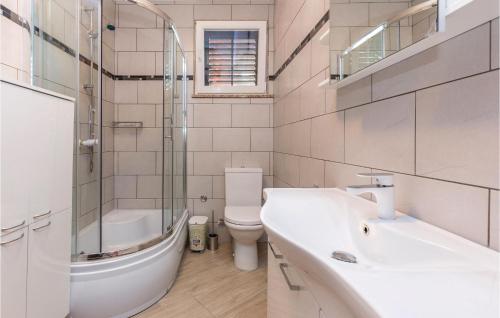 a bathroom with a sink and a toilet and a shower at 3 Bedroom Beautiful Apartment In Crikvenica in Crikvenica