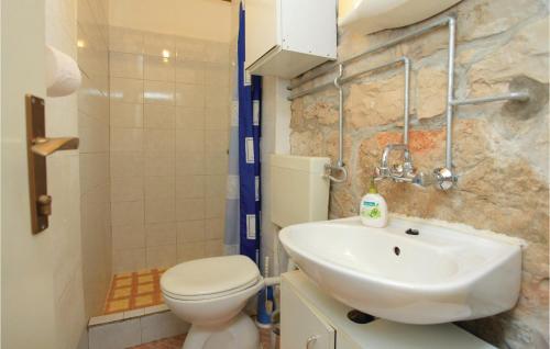 uma casa de banho com um WC branco e um lavatório. em Lovely Home In Korcula With Kitchen em Korčula