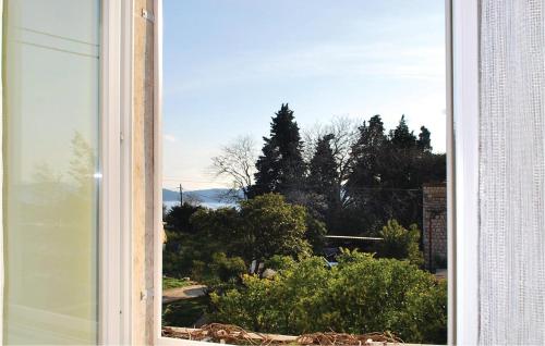 an open window with a view of trees at Holiday Home Potok Vi in Trsteno