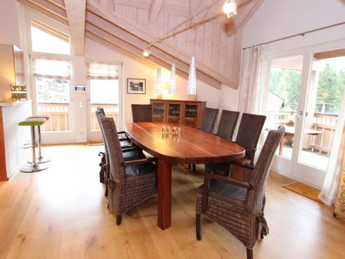 a dining room with a wooden table and chairs at Apartment near the ski area in Leogang