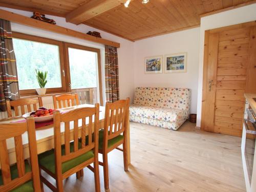 a dining room with a table and chairs and a couch at Apartment near the ski area in Saalbach Hinterglemm