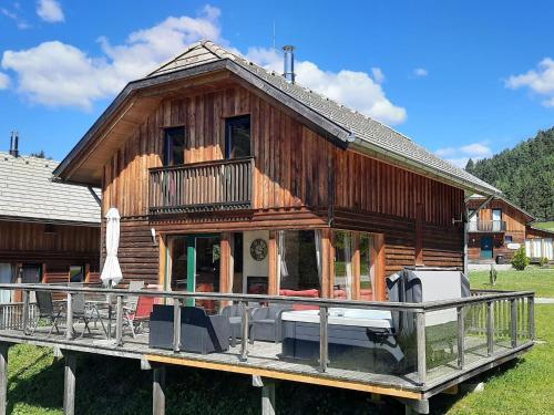 a large wooden house with a large deck at Chalet in Styria near Kreischberg Ski in Sankt Georgen ob Murau