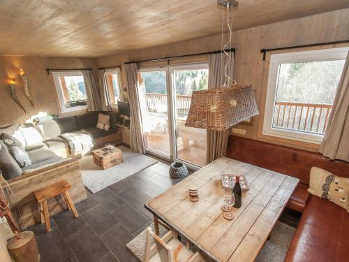 a living room with a table and a couch at Chalet in Stadl an der Mur Styria with sauna in Stadl an der Mur