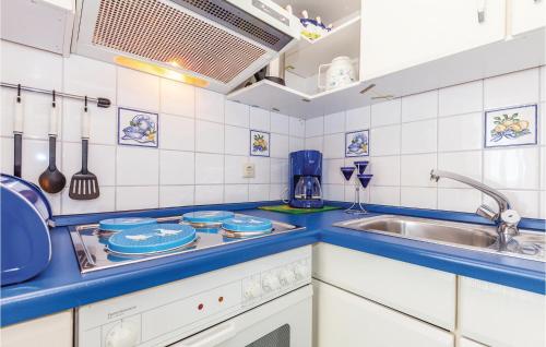 a kitchen with blue counter tops and a sink at Awesome Apartment In Crikvenica With Wifi in Crikvenica