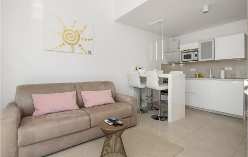 a living room with a couch and a kitchen at Gorgeous Apartment In Stinica in Stinica