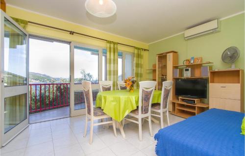 a dining room with a table and chairs and a balcony at 3 Bedroom Gorgeous Apartment In Blato in Prizba