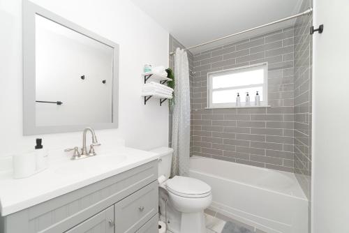 a white bathroom with a sink and a toilet at NEW Cozy House 5 Min Three Sisters Springs in Crystal River