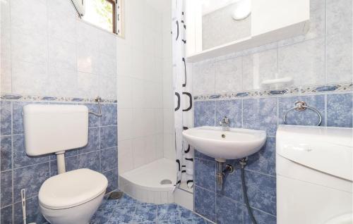 a blue and white bathroom with a toilet and a sink at Awesome Apartment In Kastel Kambelovac With Wifi in Kaštela