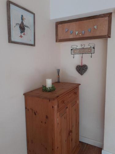 a room with a wooden cabinet and a wall at The Garage in Wimborne Minster