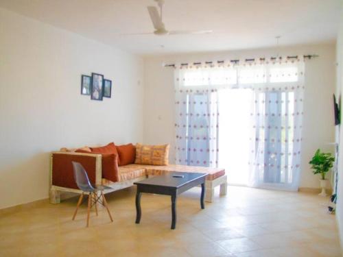 a living room with a couch and a table at Serviced 2 bedroom apartment near the ocean front in Malindi