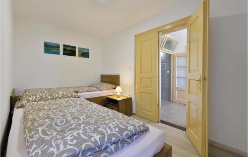 a bedroom with a bed and a yellow door at Nice Home In Ludbreg With 3 Bedrooms, Wifi And Outdoor Swimming Pool in Ludbreg