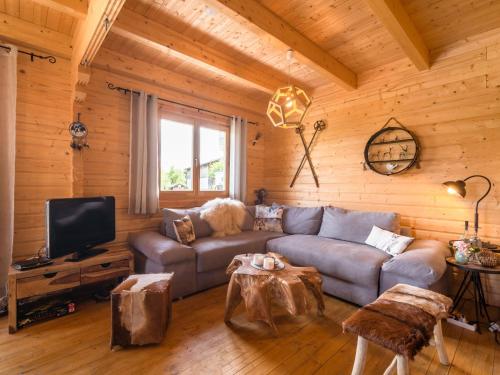 a living room with a couch and a tv at Chalet in Finkenstein on Lake Faak in Carinthia in Ledenitzen
