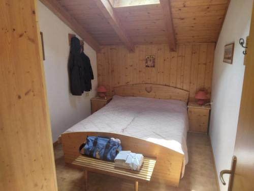 a bedroom with a bed in a wooden room at La casa di Grace nella valle incantantata in Carano
