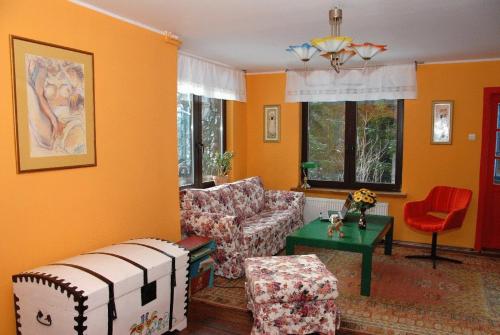 a living room with a couch and a table at Rezydencja Święty Spokój in Wisła