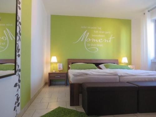 a bedroom with two beds and a green wall at Casa-Maria in Ehrenberg