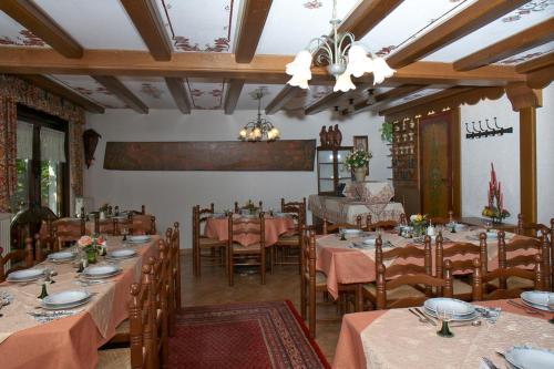 a restaurant with tables and chairs in a room at Maischeider Hof in Kleinmaischeid