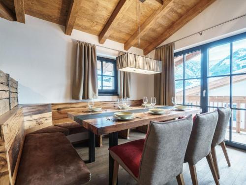 a dining room with a wooden table and chairs at Luxurious holiday home in Piesendorf with sauna in Piesendorf