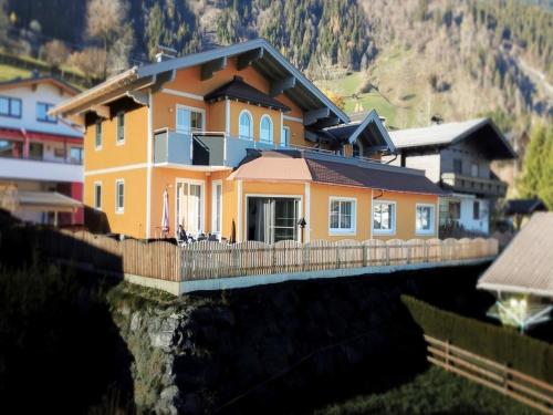 ein Haus auf einer Brücke über einen Fluss in der Unterkunft Luxurious Mansion in Goldegg near Skiing Area in Goldegg