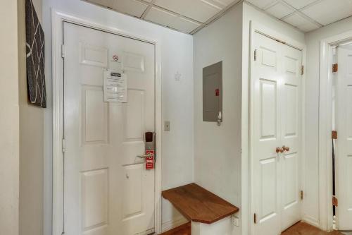 a hallway with a white door and a wooden bench at Pico C103 in Killington