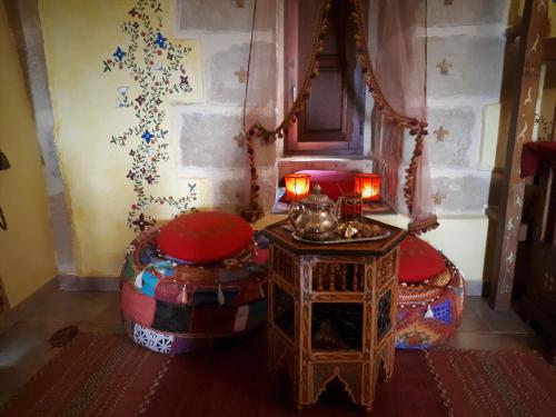 a room with two stools and a table with candles at TORRE FUERTE Siglo XIII in Baños de Rioja