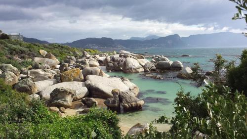 a group of large rocks in the water at Boulders Beach Hotel, Cafe and Curio shop in Simonʼs Town