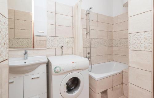 a bathroom with a washing machine and a sink at Nice Apartment In Zadar With Wifi in Zadar