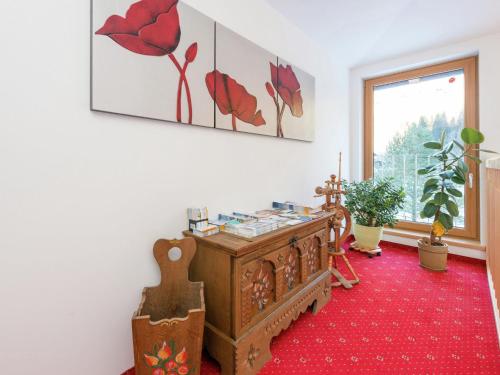 a room with a dresser and a red carpet at Cozy apartment in Wald K nigsleiten in Wald im Pinzgau
