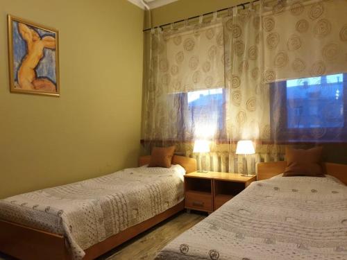 a bedroom with two beds and a window at Ierullē in Alūksne