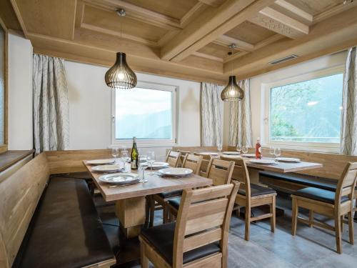 a dining room with wooden tables and chairs at Chalet in Koenigsleiten near ski area with sauna in Königsleiten