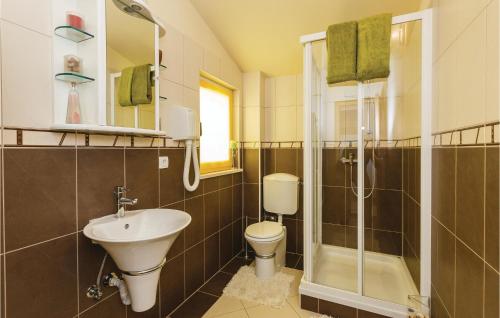 a bathroom with a toilet and a sink and a shower at Beautiful Apartment In Kastel Stari With 1 Bedrooms And Wifi in Kaštela