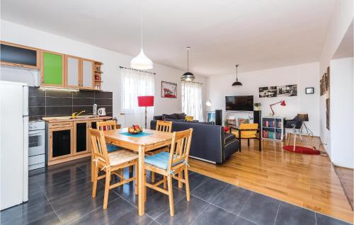 a kitchen and living room with a table and chairs at Amazing Apartment In Sibenik With Kitchen in Šibenik