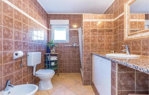 a bathroom with a toilet and two sinks at 1 Bedroom Amazing Apartment In Bribir in Bribir