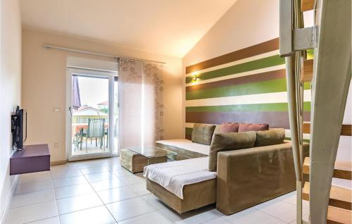 Una sala de estar con un sofá y un balcón. en Cozy Home In Medulin With Kitchen, en Medulin