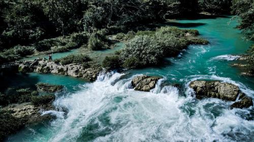 an aerial view of a river with blue water at Ch'i Bocól Community Hostel in Lanquín