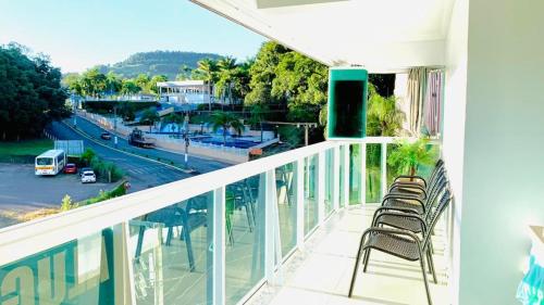 a balcony with chairs and a view of a street at Thermas Palace in Piratuba