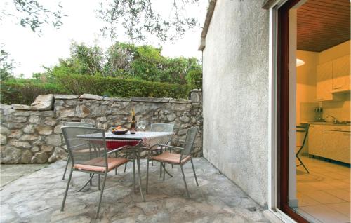 a table and chairs sitting on a patio at One-Bedroom Holiday Home in Kneze in Pupnat