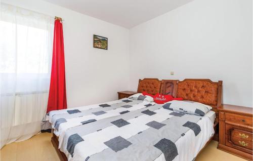 a bedroom with a bed and a red curtain at Nice Apartment In Matulji With Kitchen in Matulji