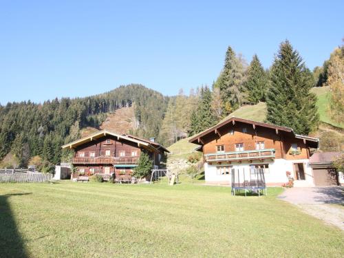 a couple of large wooden buildings in a field at Apartment in Wagrain near the ski area in Wagrain