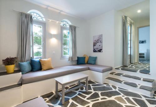 a living room with a couch and a table at Byzantio Beach Suites & Wellness in Agios Sostis