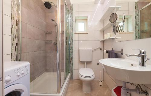 a bathroom with a toilet and a sink and a shower at Amazing Home In Novi Vinodolski With Kitchen in Novi Vinodolski