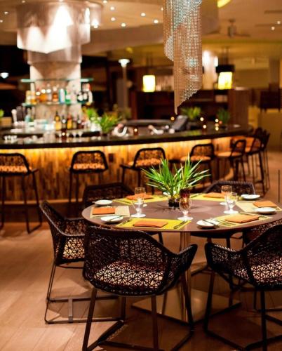 a table and chairs in a restaurant with a bar at Fairmont Kea Lani, Maui in Wailea