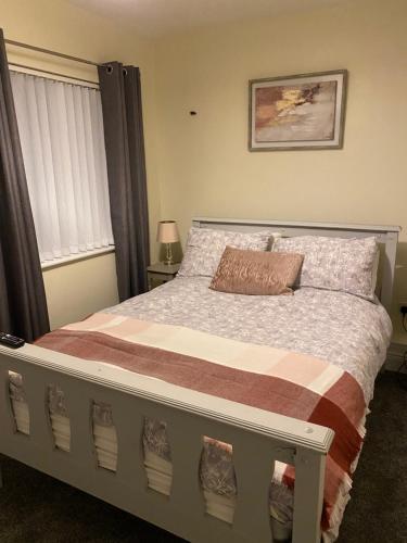 a bedroom with a large bed with a pillow on it at The Strand Guest House in Falcarragh