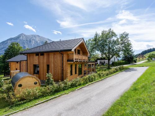 a wooden house with a road in front of it at Chalet in Tauplitz with sauna in ski area in Tauplitz