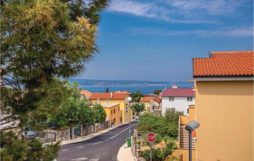 a street with yellow houses and a stop sign at Gorgeous Home In Selce With Wifi in Selce
