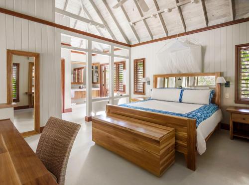 a bedroom with a bed and a table and chairs at GoldenEye in Oracabessa