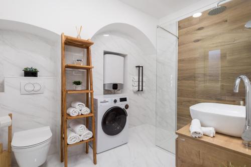 a bathroom with a washing machine and a sink at Apartman Anja in Rijeka
