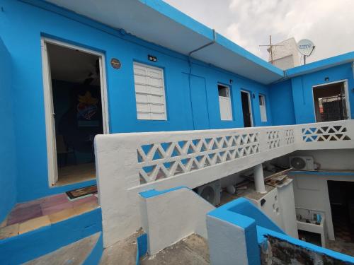 a blue house with a balcony and a door at Chuchumbé Hotel & Hostal in Veracruz