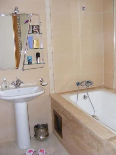 a bathroom with a sink and a bath tub next to a sink at Appartement Hamria Meknes in Meknès