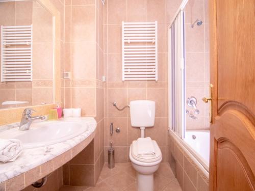 a bathroom with a toilet and a sink at Apartments and Rooms Levantin Inn in Sveti Stefan