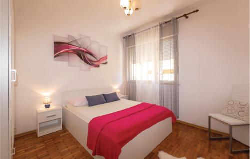 a bedroom with a bed with a red blanket at Beautiful Apartment In Zadar With 2 Bedrooms, Wifi And Outdoor Swimming Pool in Zadar